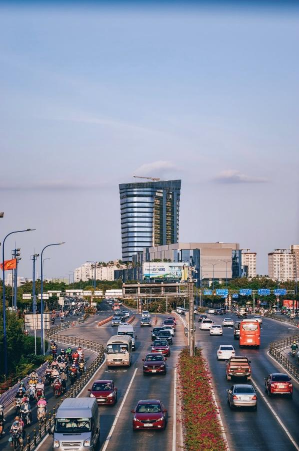 cars on road near city buildings during daytime